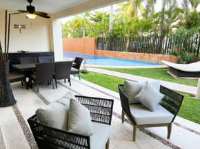 Relax, with our beautiful gardens, large pool and just steps from the beach and lagoon